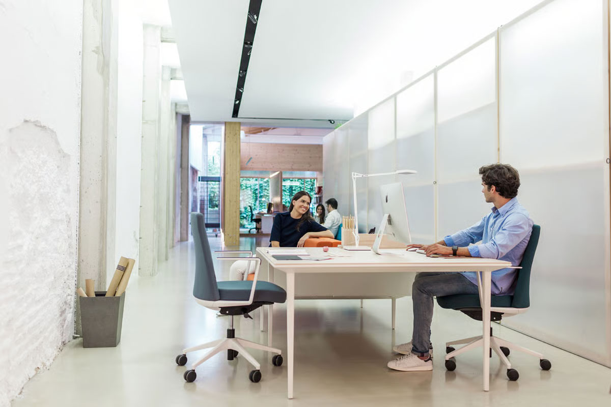 Longo es el programa de mesas y soft seating que destaca por su ligereza visual y prestaciones ergonómicas Mesa Longo en mesa de reunión de oficina técnica de diseño