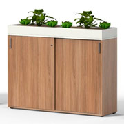 Armario Actiu con puerta corredera y trasera en madera color castaño y jardinera superior para oficina de diseño