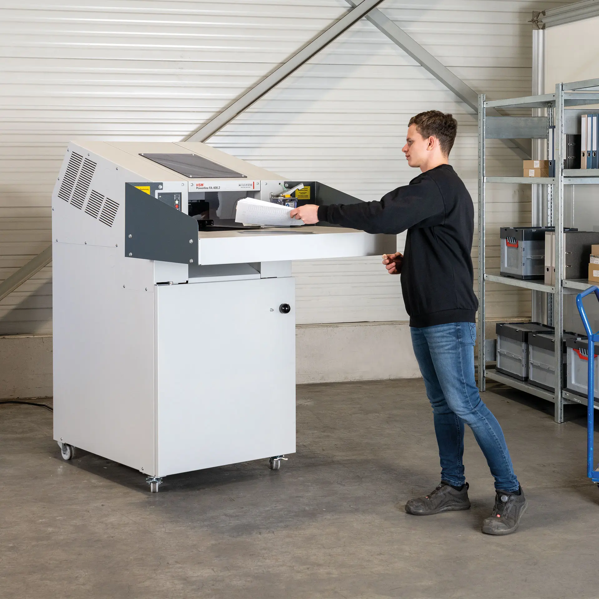 Operario destruyendo en destructora de documentos industrial